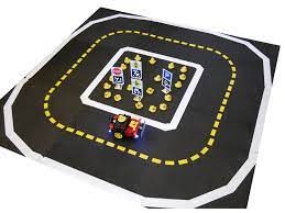 Gray foam tiles arranged in a ring with white and yellow tape lane markers